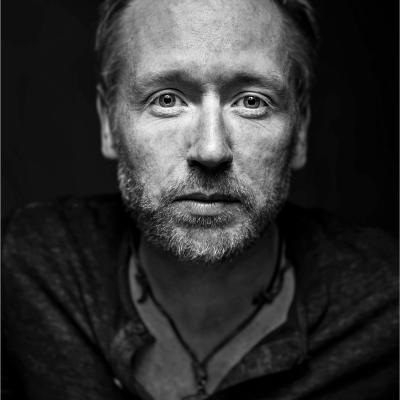 Mono image of Ash Cooper in moody lighting