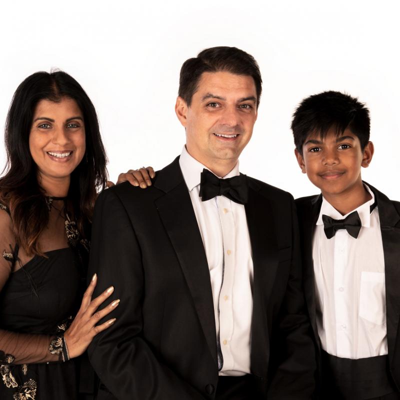 A portrait of a husband, wife and son